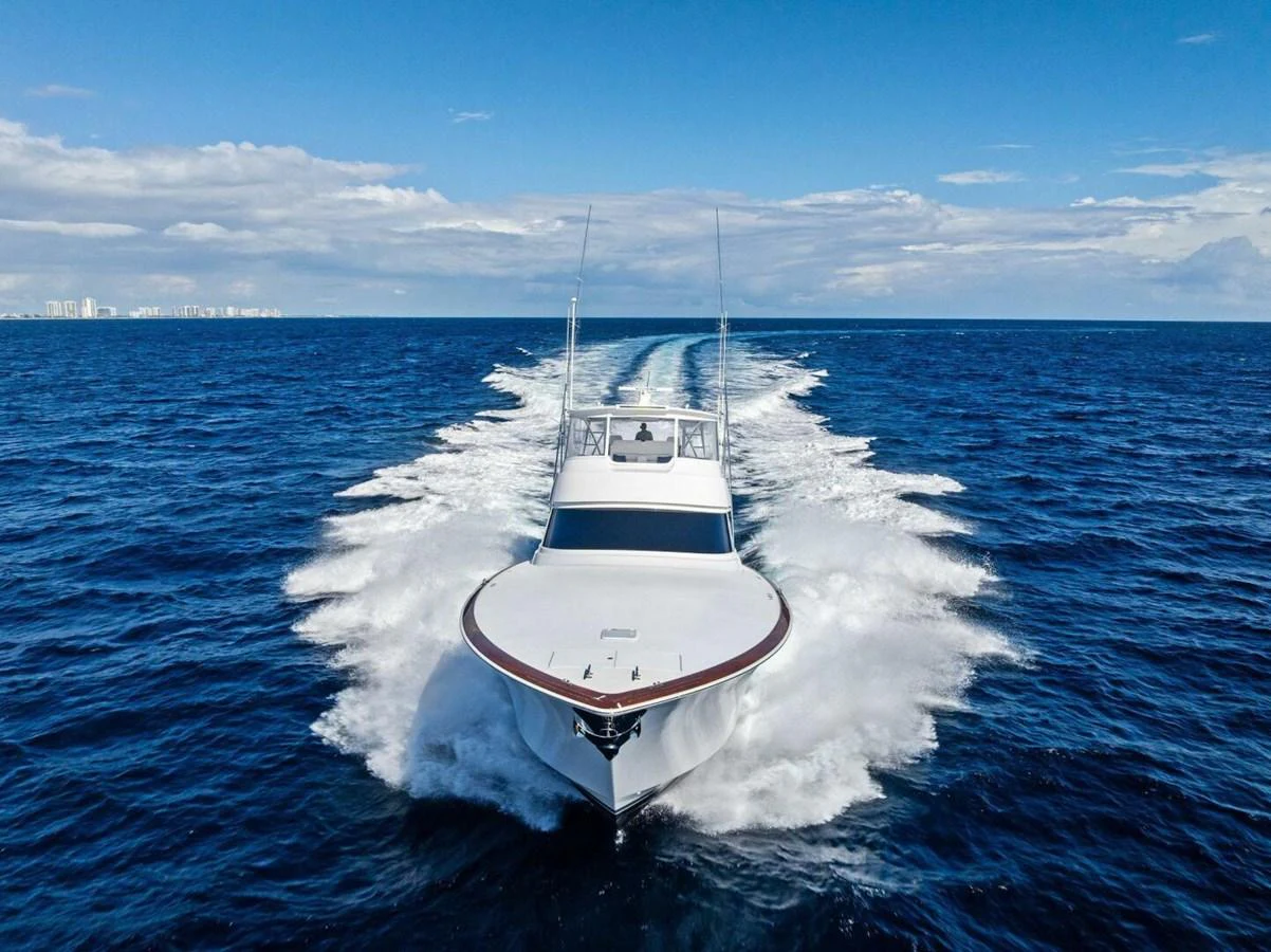 A sleek yacht cruises powerfully through open waters, leaving a trail of white foam behind. aboard TEAM HARVEY I Yacht for Sale