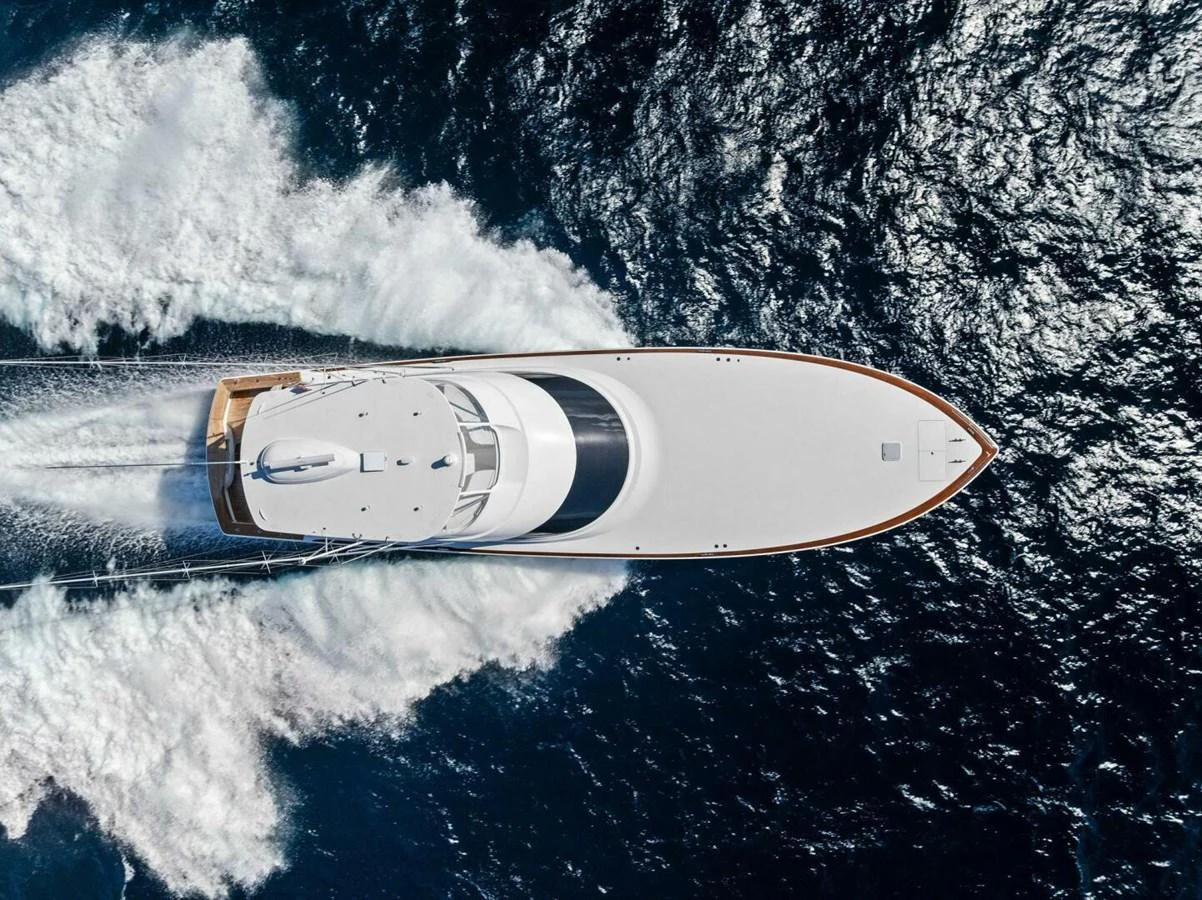 An aerial view of a sleek yacht cutting through the water with impressive speed. aboard TEAM HARVEY I Yacht for Sale