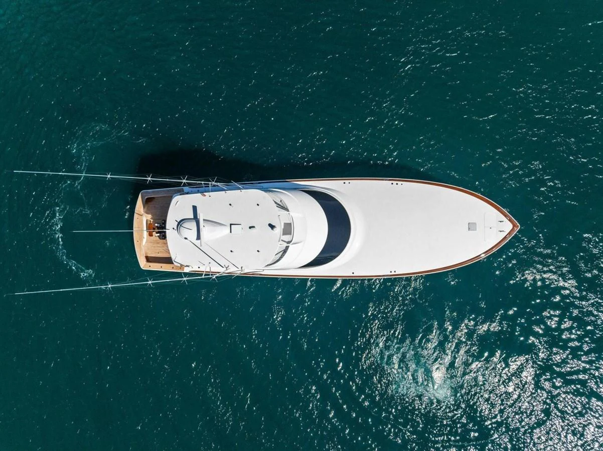 A sleek yacht glides gracefully on the open water, showcasing its elegant design from an aerial perspective. aboard TEAM HARVEY I Yacht for Sale