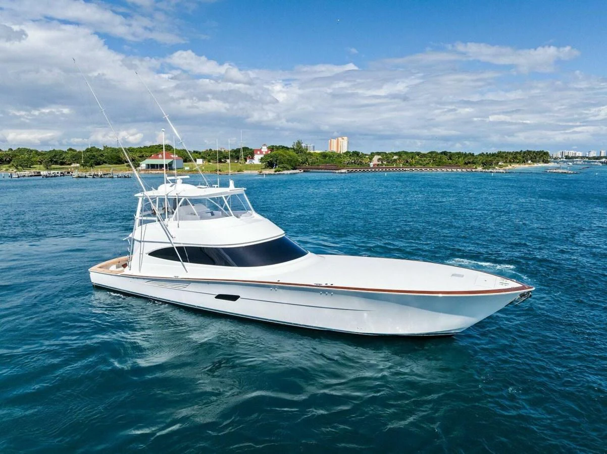 A sleek yacht cruises through clear blue waters under a bright sky. aboard TEAM HARVEY I Yacht for Sale