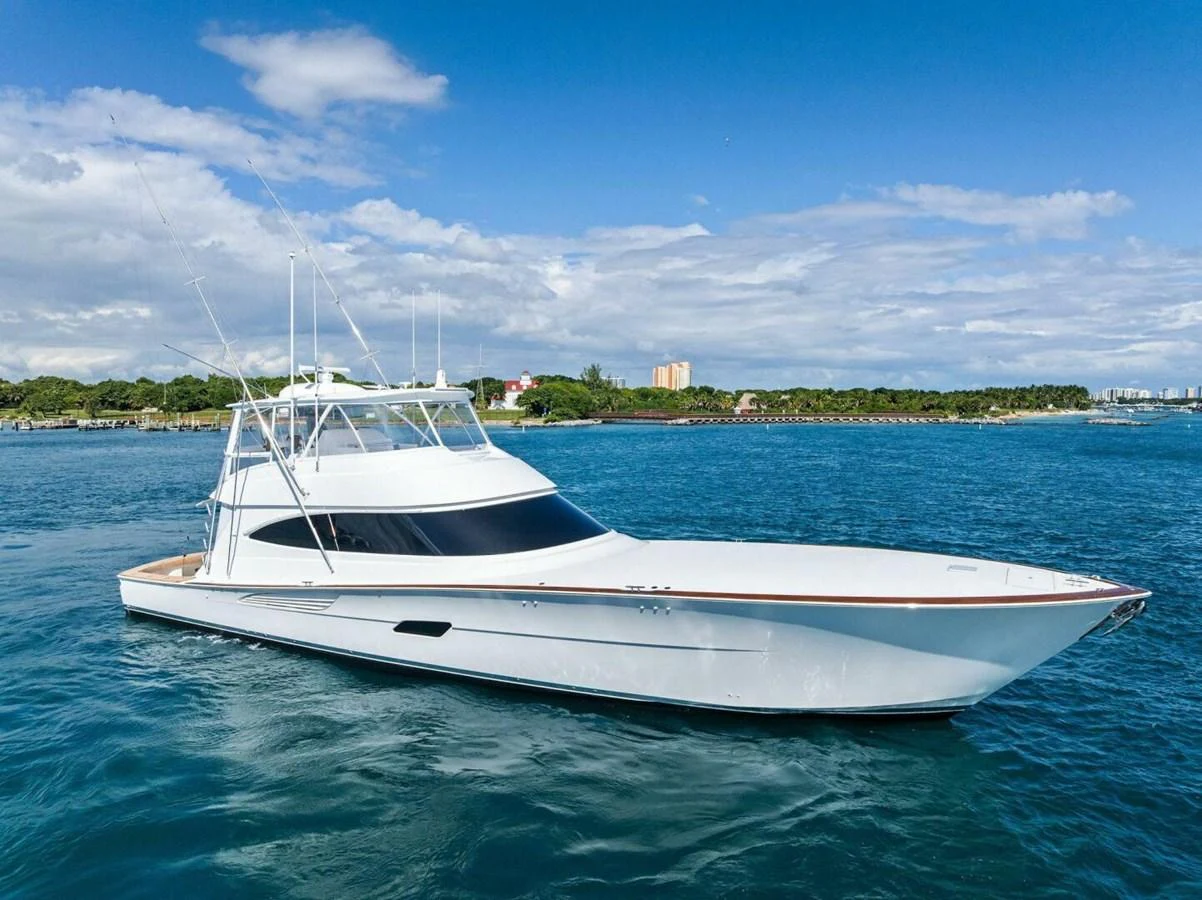 A sleek yacht glides gracefully on calm blue waters under a clear sky. aboard TEAM HARVEY I Yacht for Sale