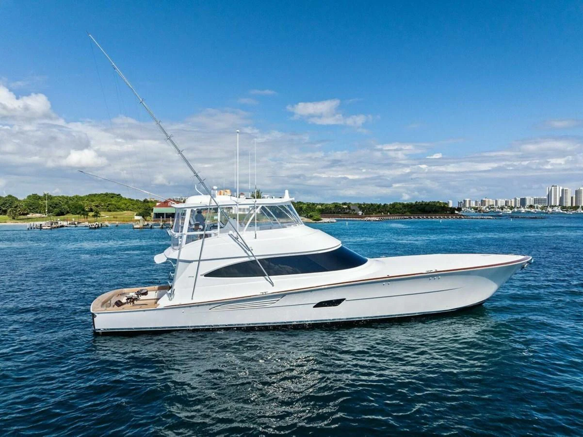 A sleek and modern yacht cruises gracefully on calm waters under a clear blue sky. aboard TEAM HARVEY I Yacht for Sale