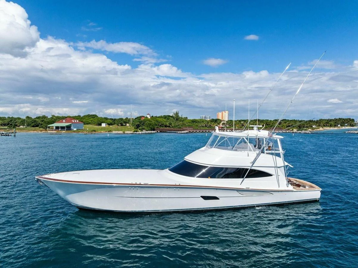 A sleek yacht glides gracefully on calm waters under a clear blue sky. aboard TEAM HARVEY I Yacht for Sale