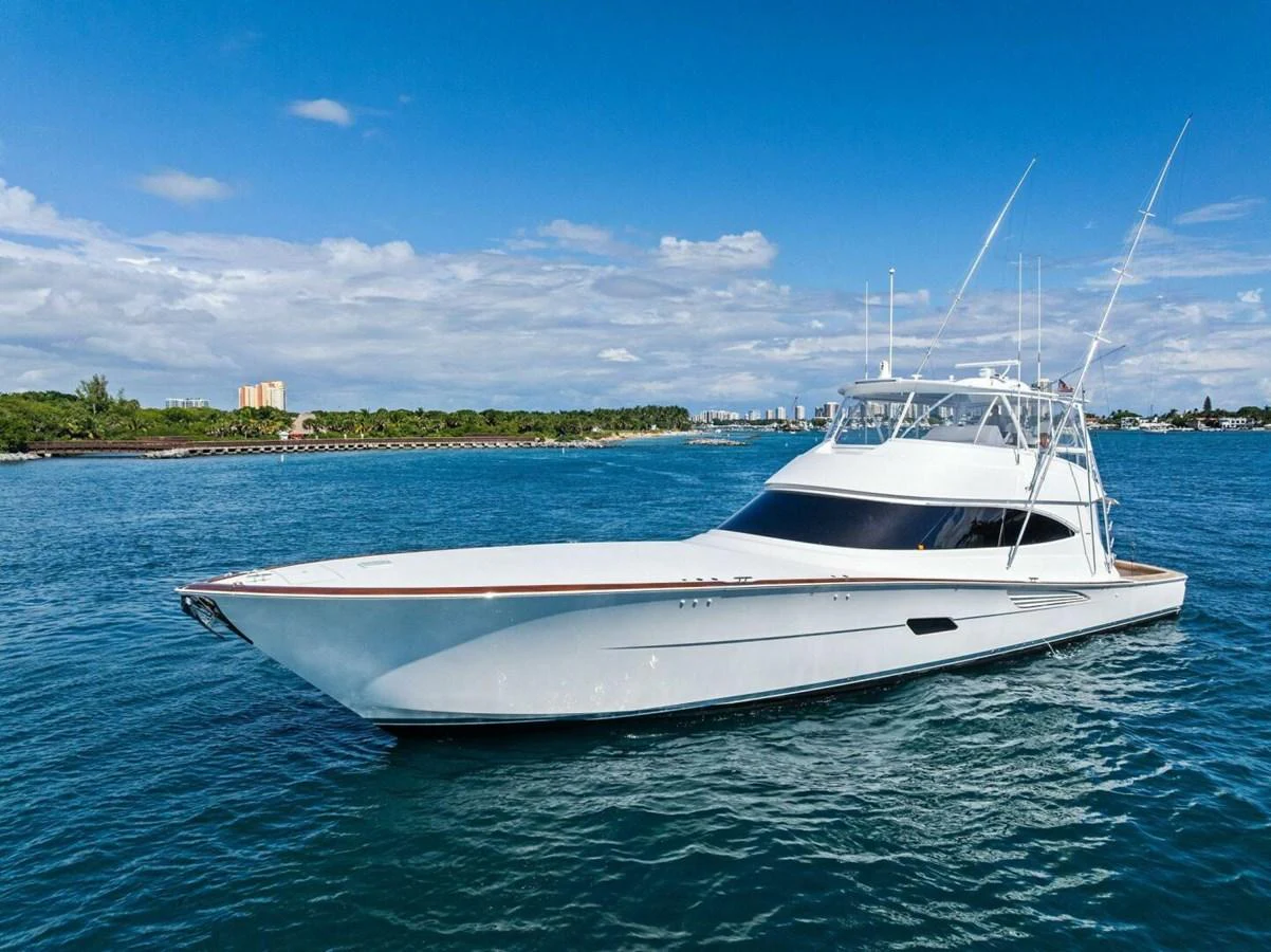A sleek and elegant yacht glides gracefully on the serene blue waters under a clear sky. aboard TEAM HARVEY I Yacht for Sale