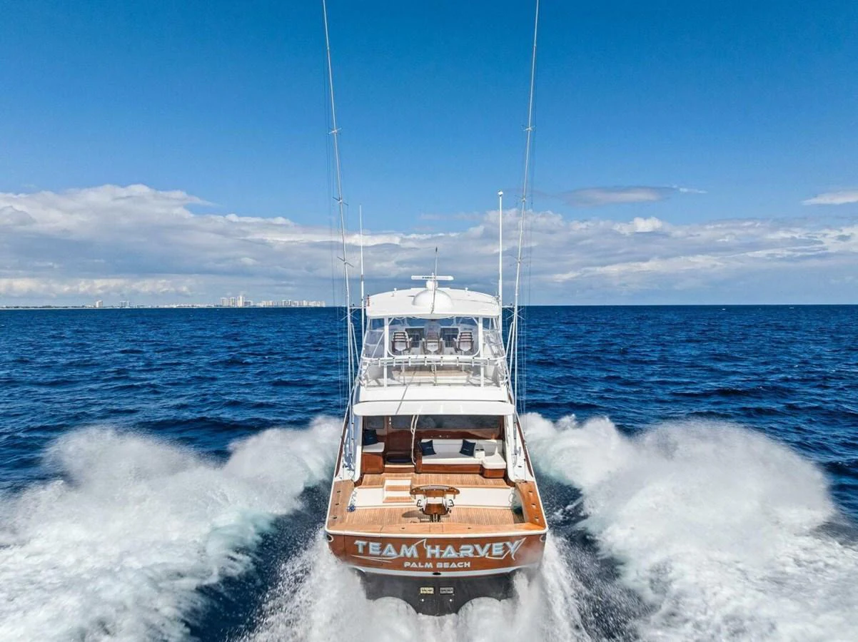 The yacht is seen cruising on open water, showcasing its powerful performance and sleek design. aboard TEAM HARVEY I Yacht for Sale