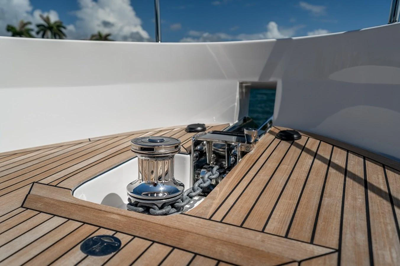 A close-up view of the yacht's anchor windlass system on a teak deck. aboard NEW BOAT Yacht for Sale