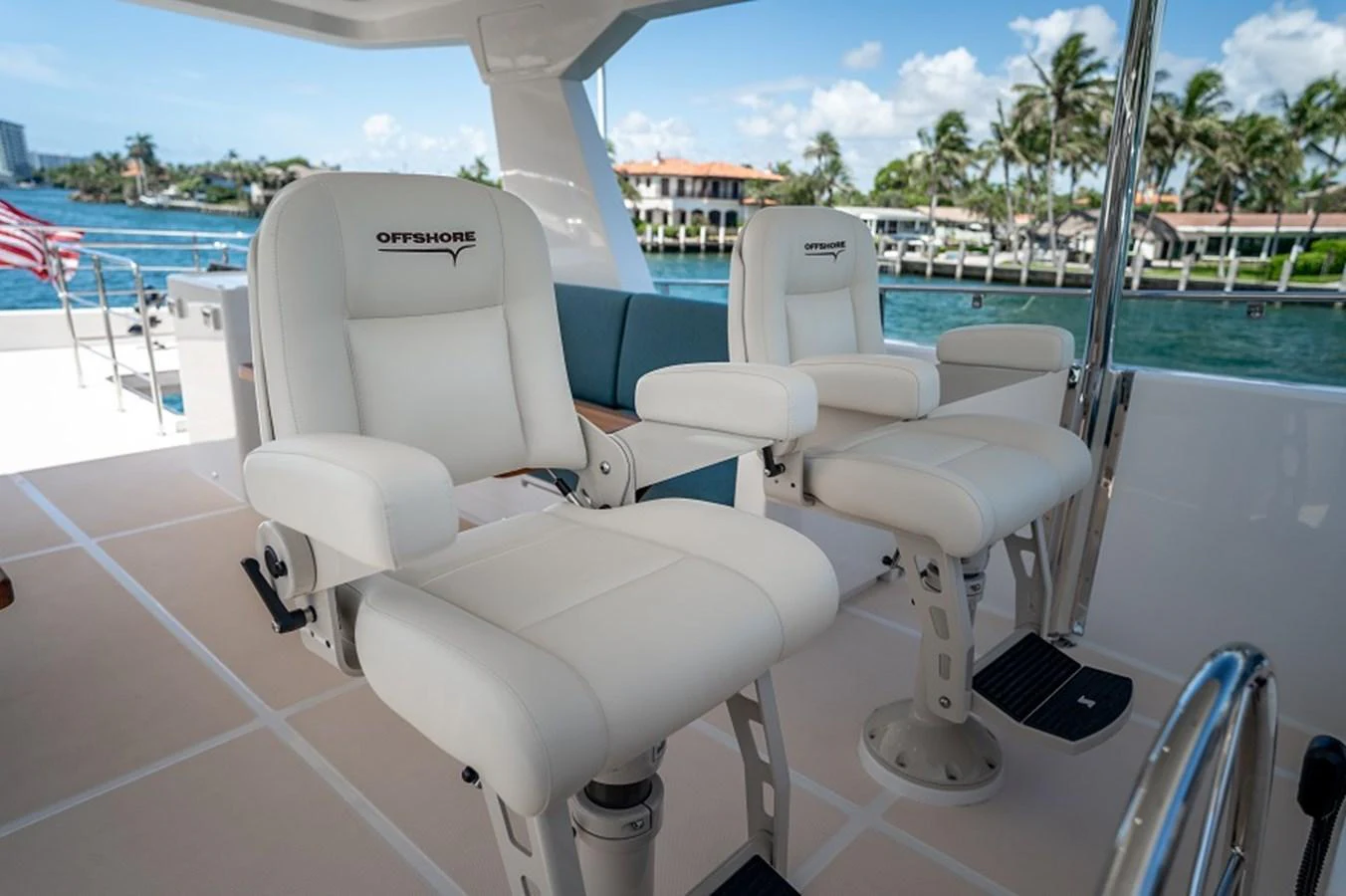 The helm area features luxurious white captain's chairs with a scenic view of the waterway. aboard NEW BOAT Yacht for Sale