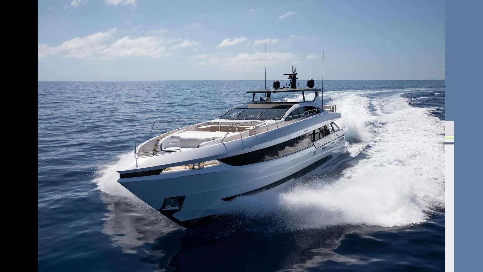 A sleek, modern yacht cruising at high speed on open water under a clear sky. aboard ARTEMIS Yacht for Sale