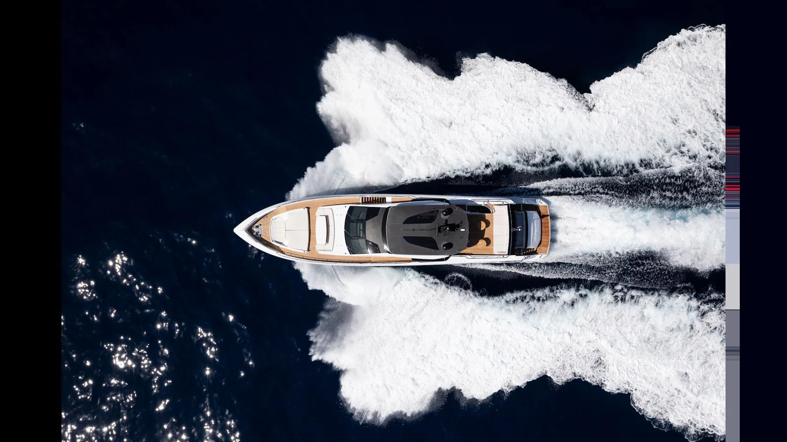 A sleek yacht cruises swiftly through the water, leaving a dynamic wake behind. aboard ARTEMIS Yacht for Sale