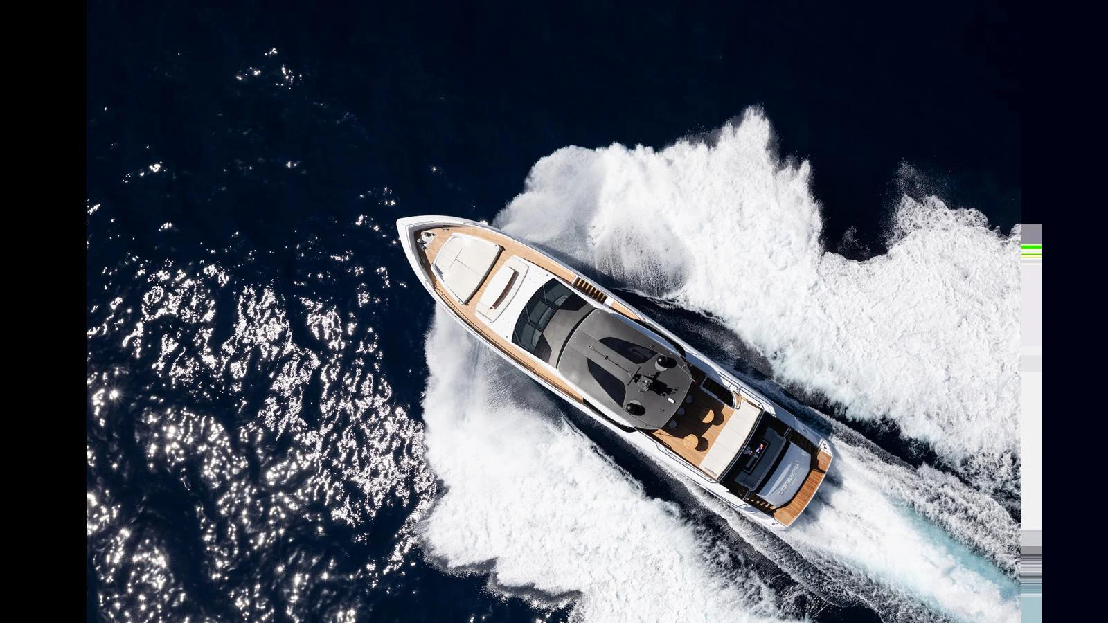 A sleek yacht cruises swiftly through the open water, leaving a trail of white wake behind. aboard ARTEMIS Yacht for Sale