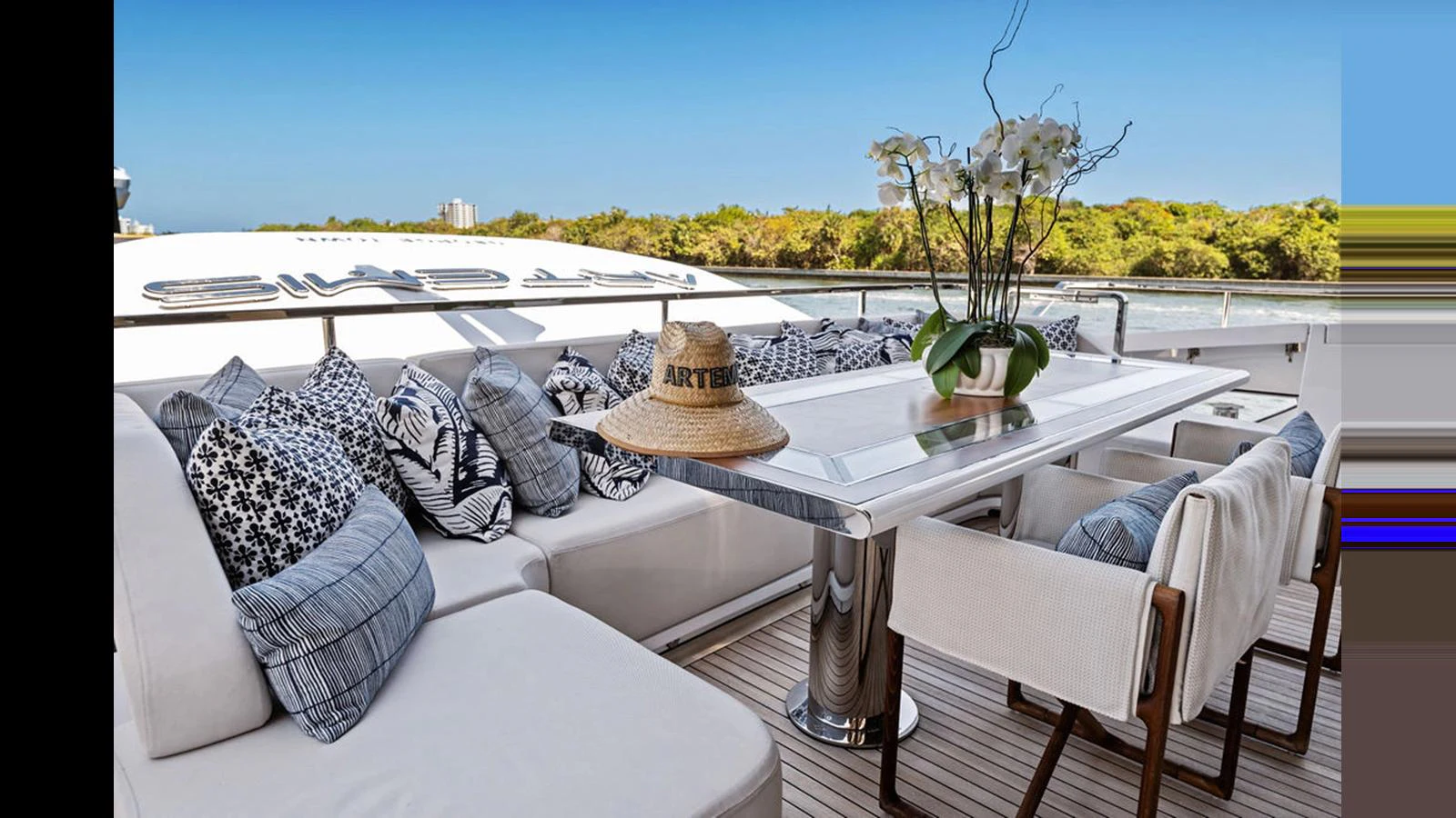 The aft deck features a stylish dining area with comfortable seating and elegant decor. aboard ARTEMIS Yacht for Sale