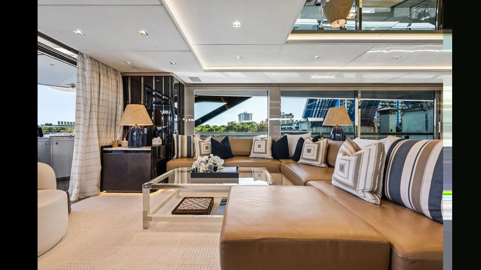 The salon features a spacious and elegant seating area with large windows providing ample natural light. aboard ARTEMIS Yacht for Sale