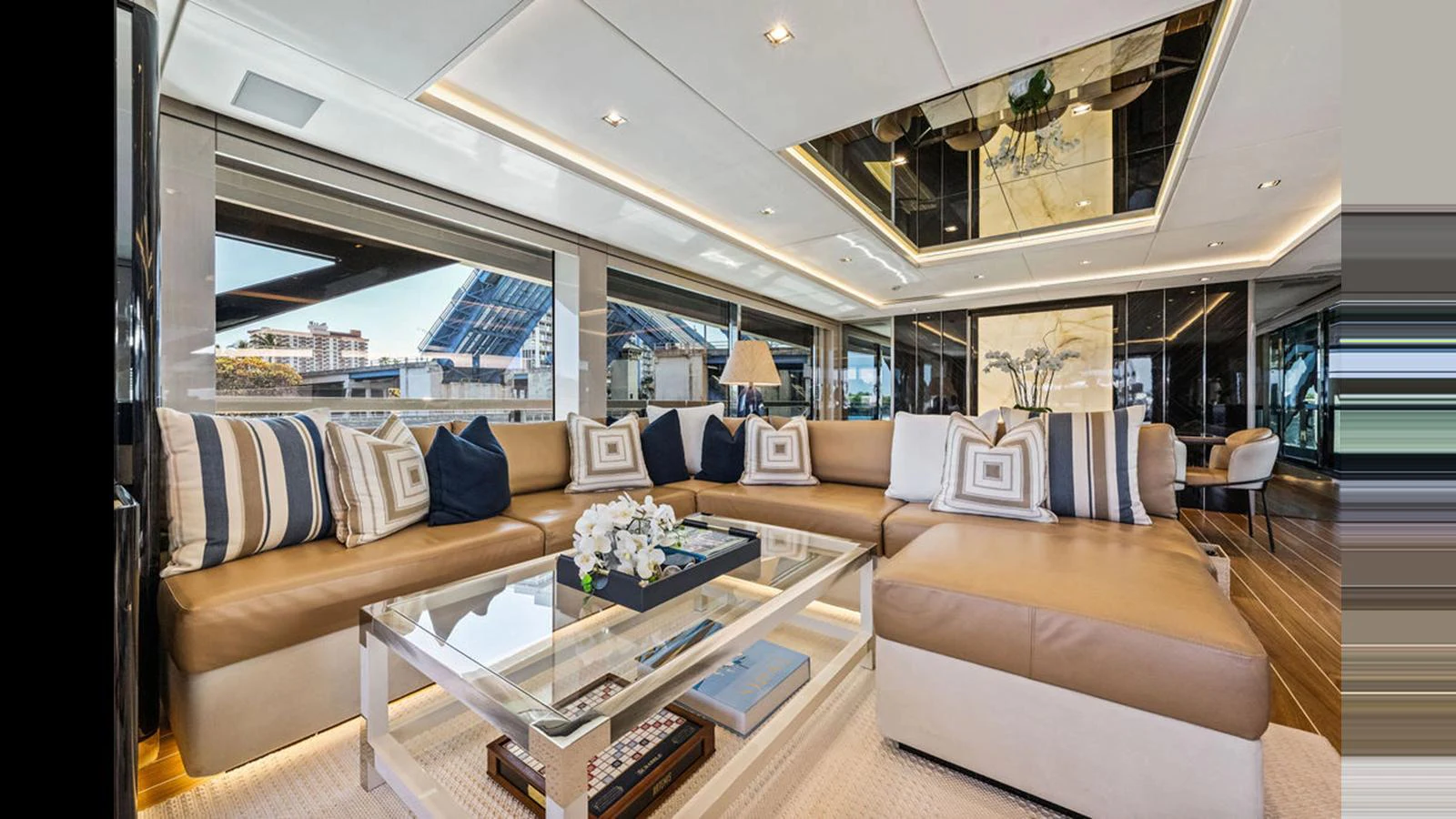 The salon features a spacious and luxurious seating area with elegant decor and ample natural light. aboard ARTEMIS Yacht for Sale