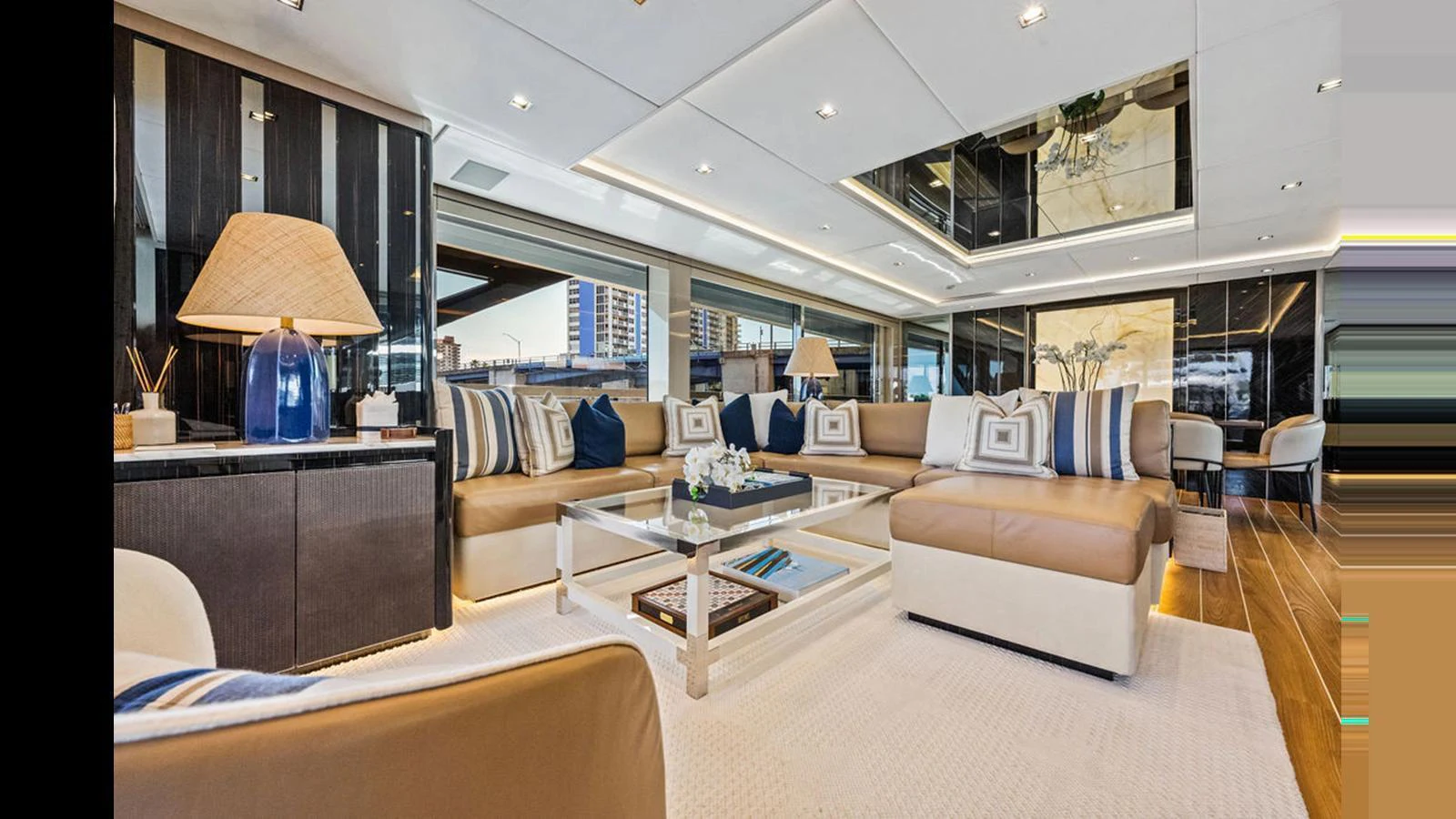 The salon features luxurious seating with elegant decor and ample natural light. aboard ARTEMIS Yacht for Sale
