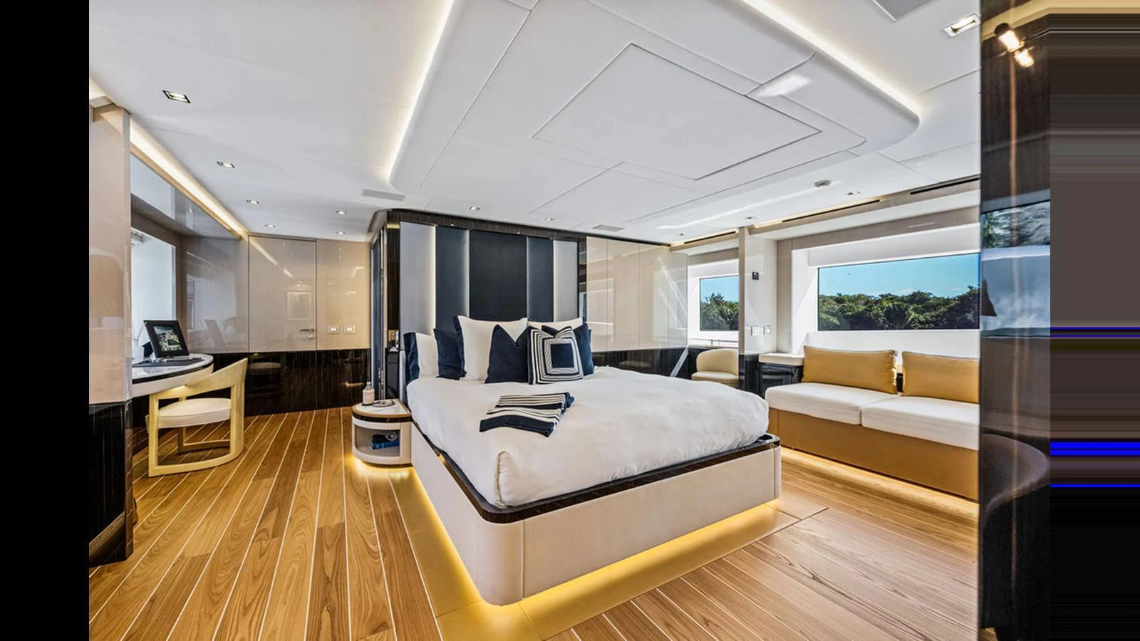 The master stateroom features a luxurious bed, elegant seating, and ample natural light. aboard ARTEMIS Yacht for Sale