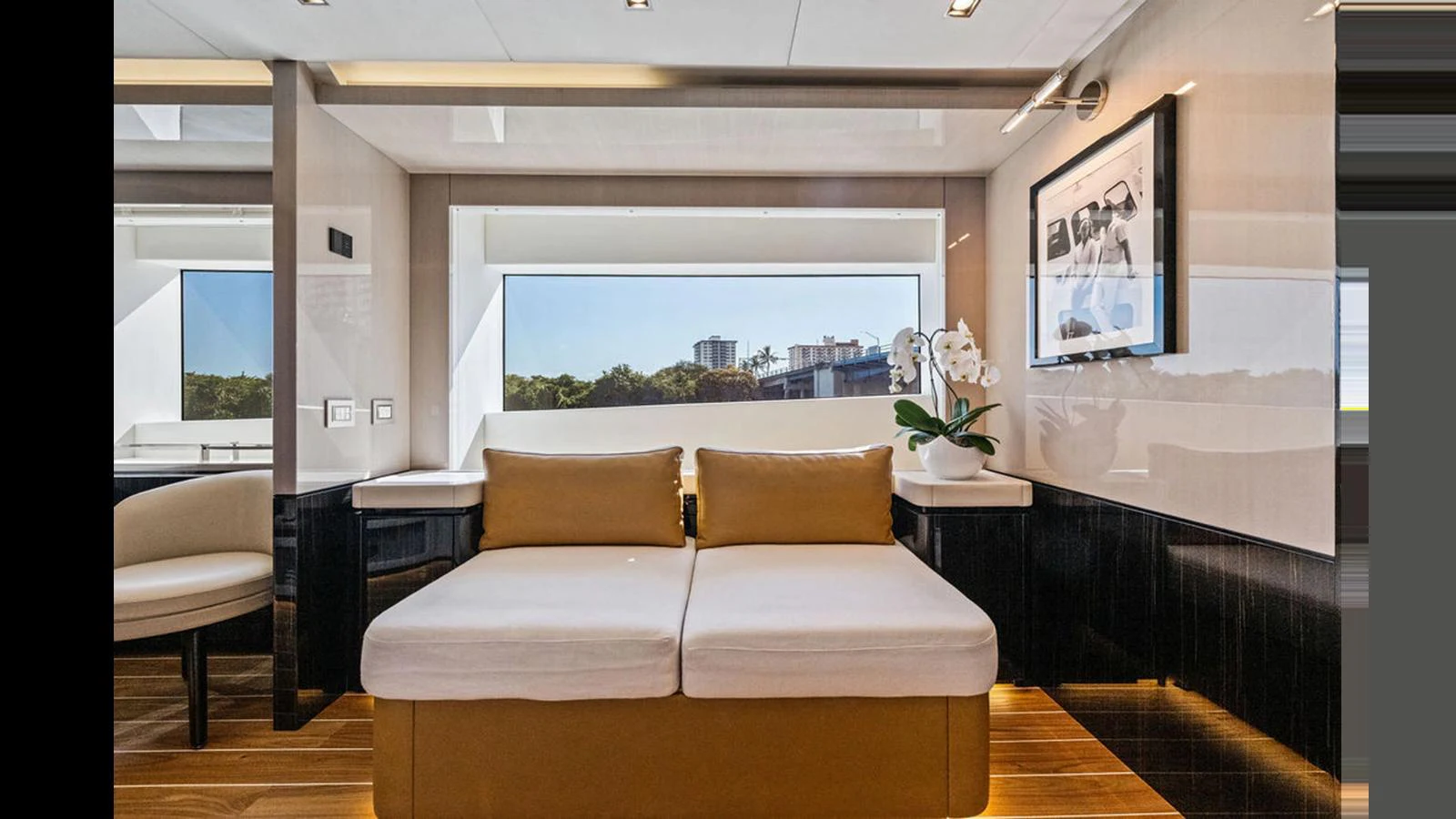 The salon features a comfortable seating area with large windows offering scenic views. aboard ARTEMIS Yacht for Sale