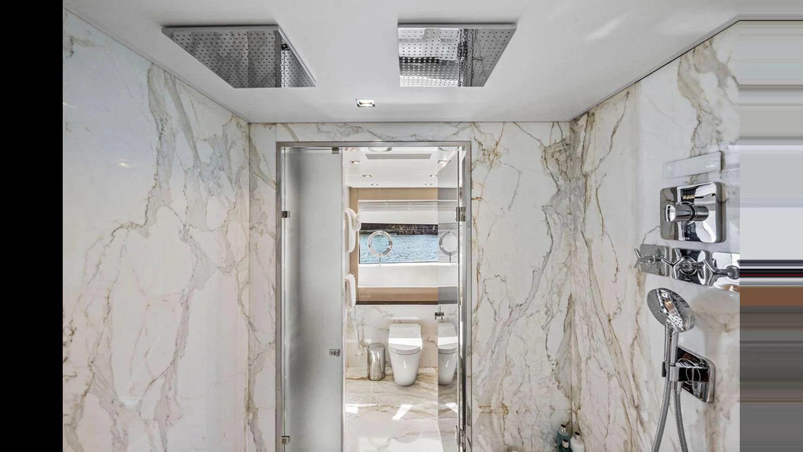 The yacht's bathroom features luxurious marble walls and modern fixtures. aboard ARTEMIS Yacht for Sale