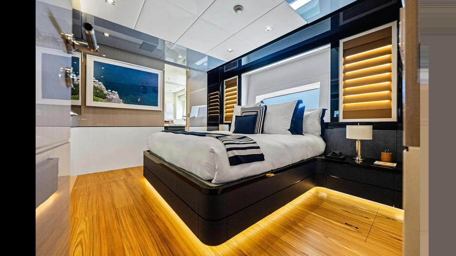 The stateroom features a luxurious bed with elegant lighting and modern decor. aboard ARTEMIS Yacht for Sale