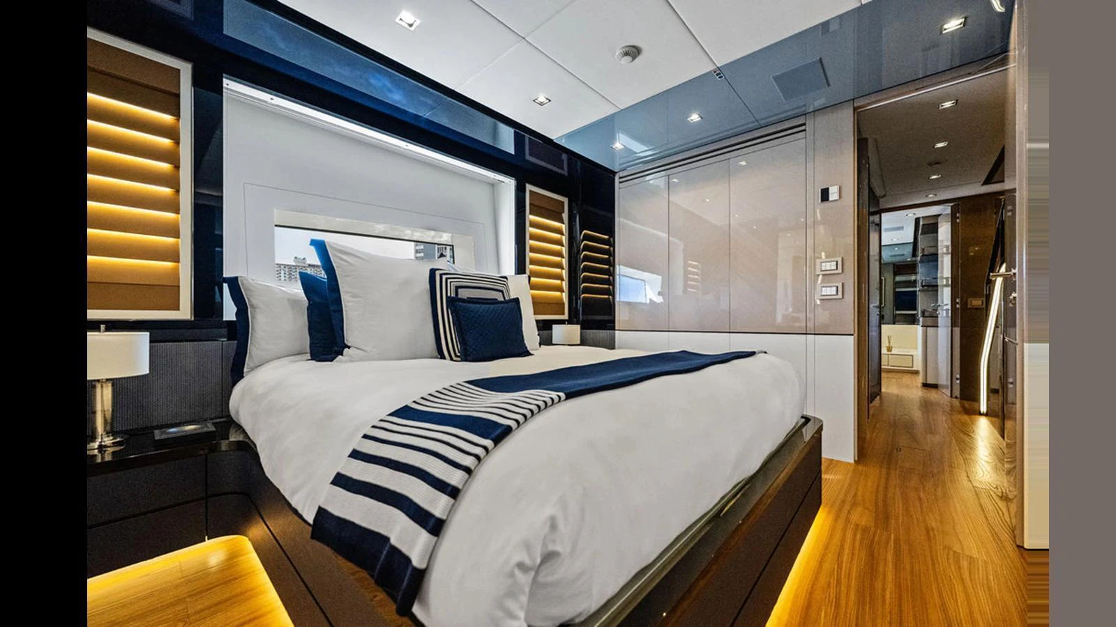 The stateroom features a luxurious bed with elegant lighting and modern decor. aboard ARTEMIS Yacht for Sale