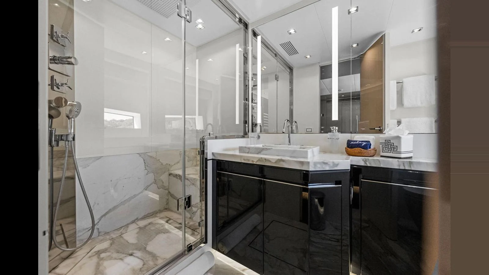 The yacht's bathroom features a luxurious design with marble accents and modern fixtures. aboard ARTEMIS Yacht for Sale