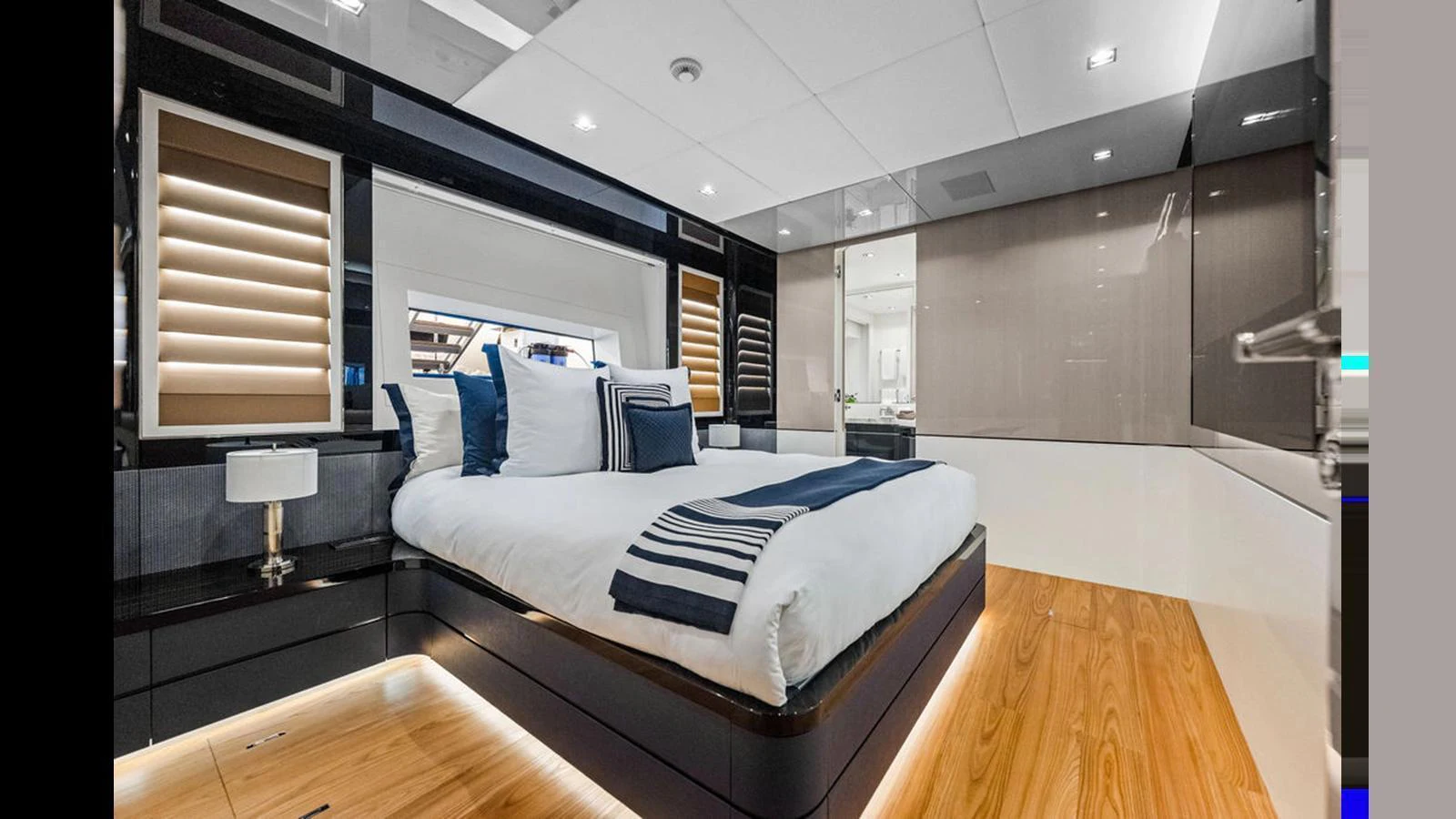 A luxurious stateroom featuring a large bed with elegant bedding and modern decor. aboard ARTEMIS Yacht for Sale