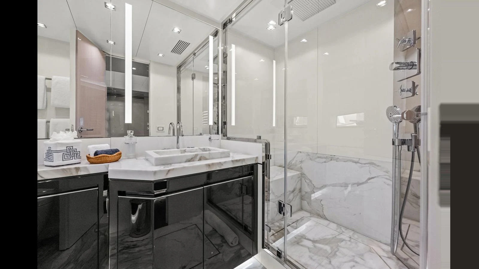 The yacht's bathroom features a sleek design with marble accents and modern fixtures. aboard ARTEMIS Yacht for Sale