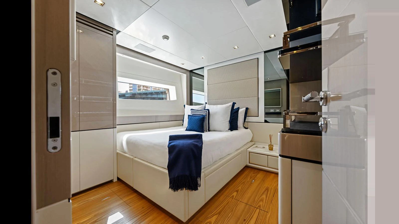 A luxurious stateroom featuring a comfortable bed with elegant bedding and modern furnishings. aboard ARTEMIS Yacht for Sale