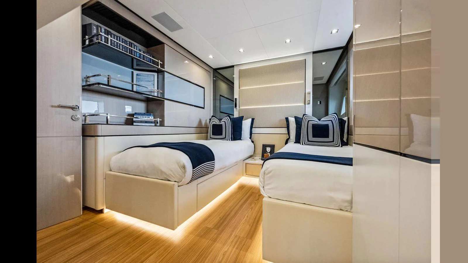 The twin stateroom features modern decor with sleek lines and ambient lighting. aboard ARTEMIS Yacht for Sale