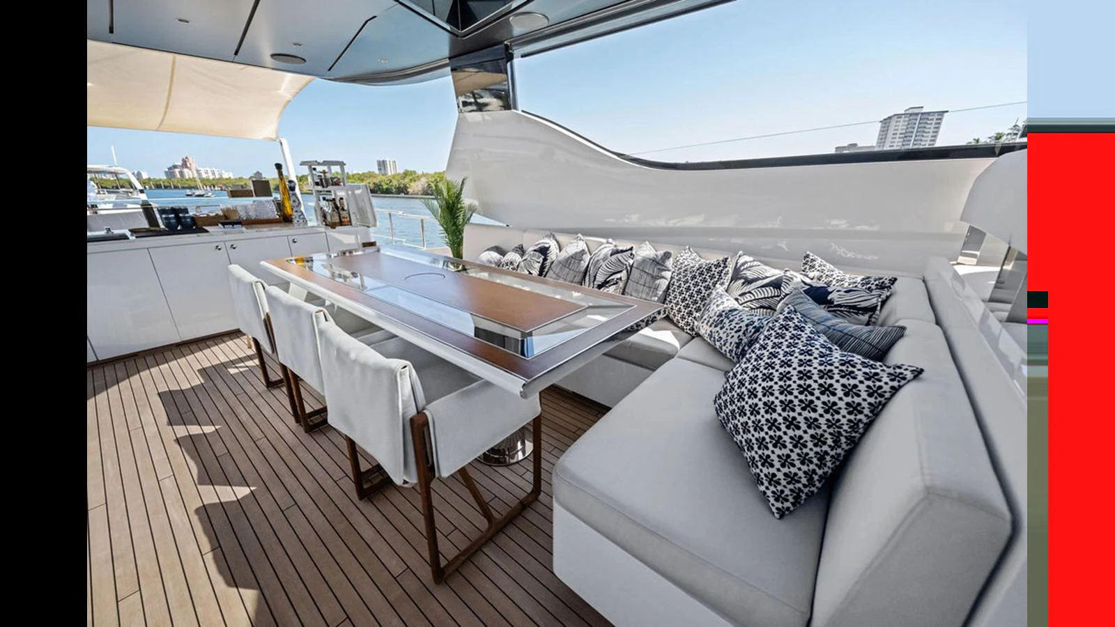 The aft deck features a spacious dining area with comfortable seating and a sleek design. aboard ARTEMIS Yacht for Sale