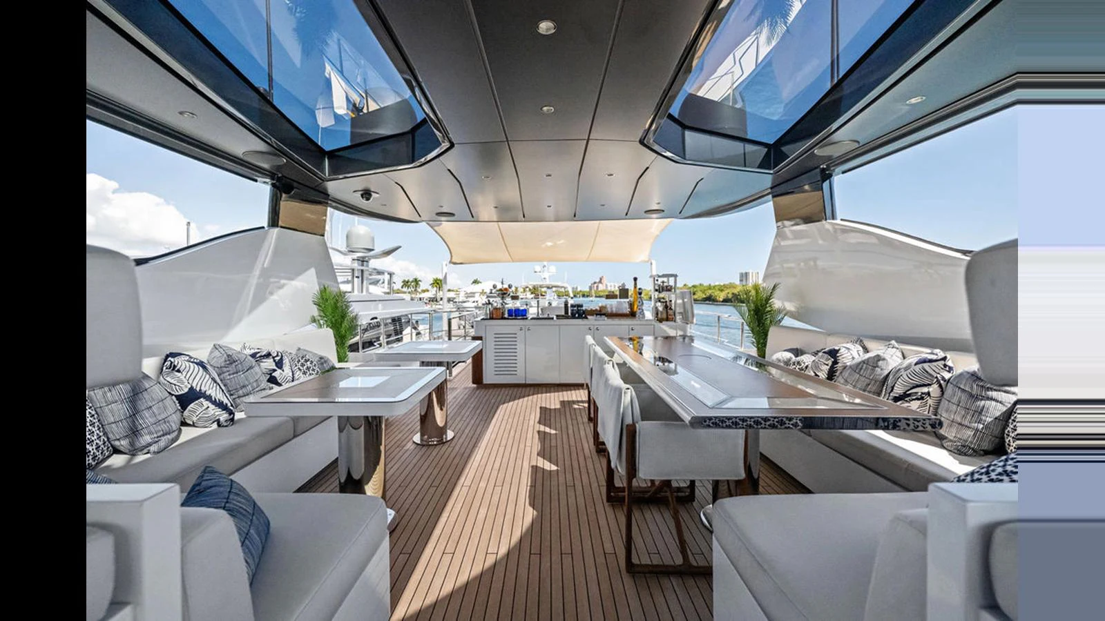 The aft deck features a spacious and stylish seating area with modern furnishings and a view of the water. aboard ARTEMIS Yacht for Sale