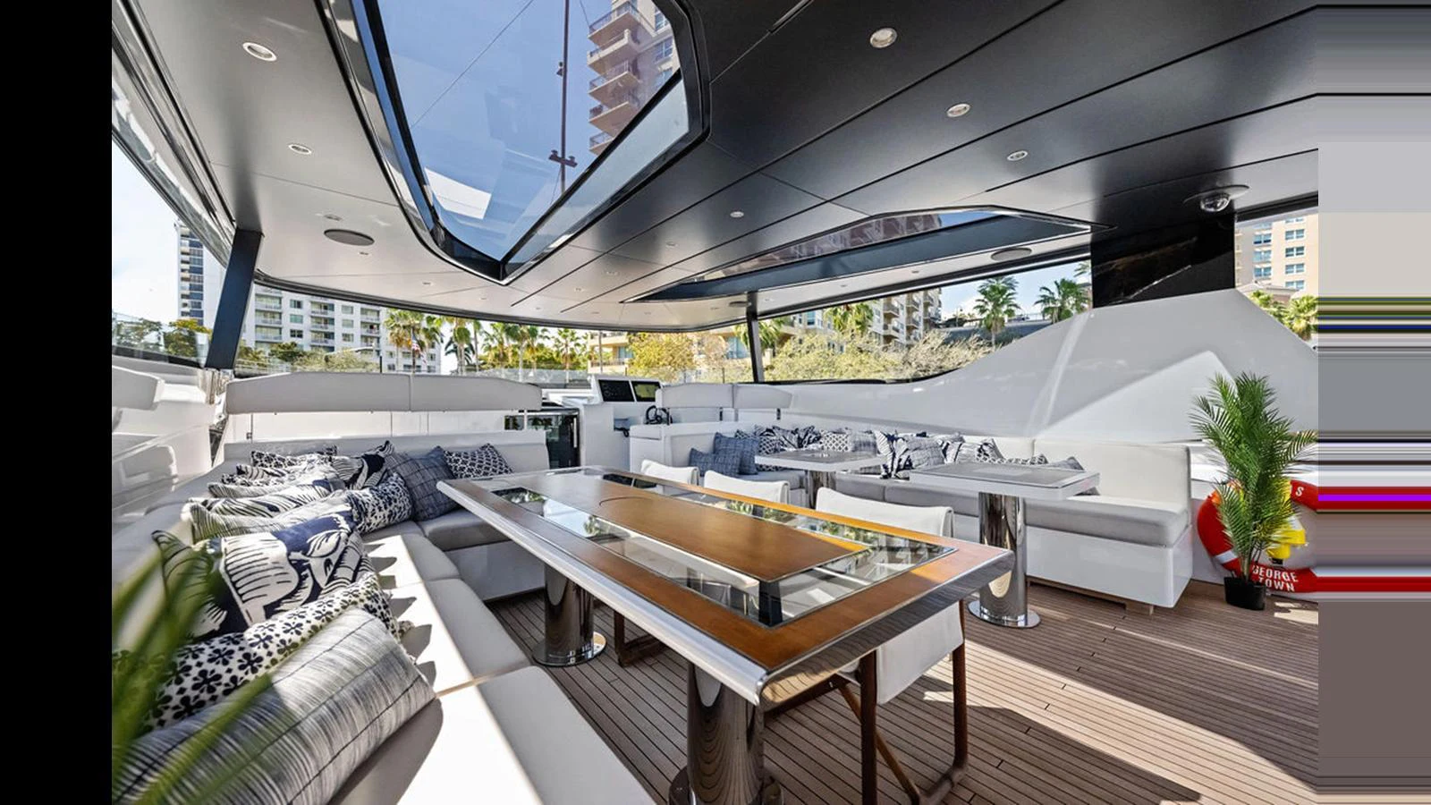The aft deck features a spacious seating area with a large table, perfect for outdoor dining and relaxation. aboard ARTEMIS Yacht for Sale