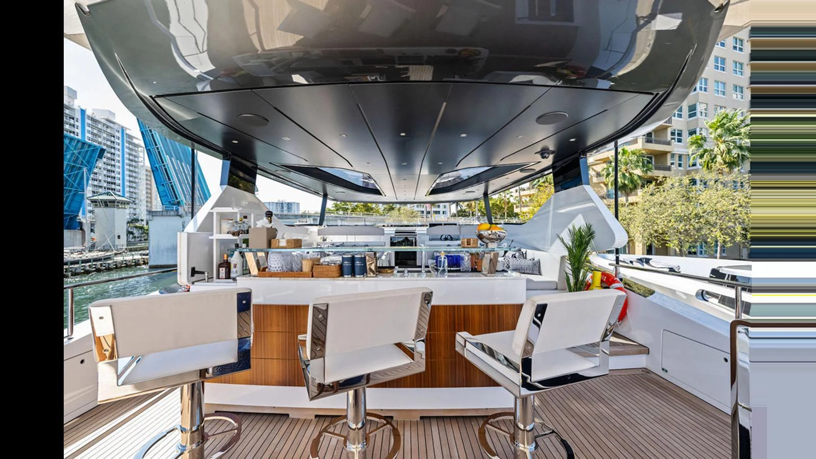 The yacht features a stylish outdoor bar area with modern seating and a sleek design. aboard ARTEMIS Yacht for Sale