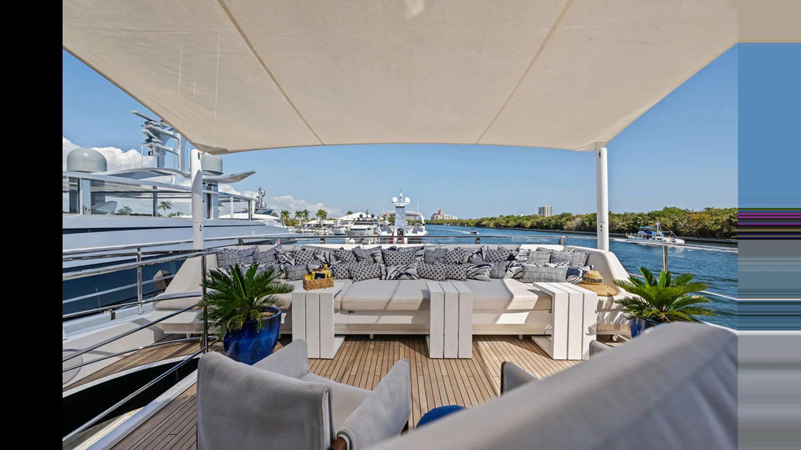 The sundeck offers a luxurious lounging area with plush seating and scenic views. aboard ARTEMIS Yacht for Sale