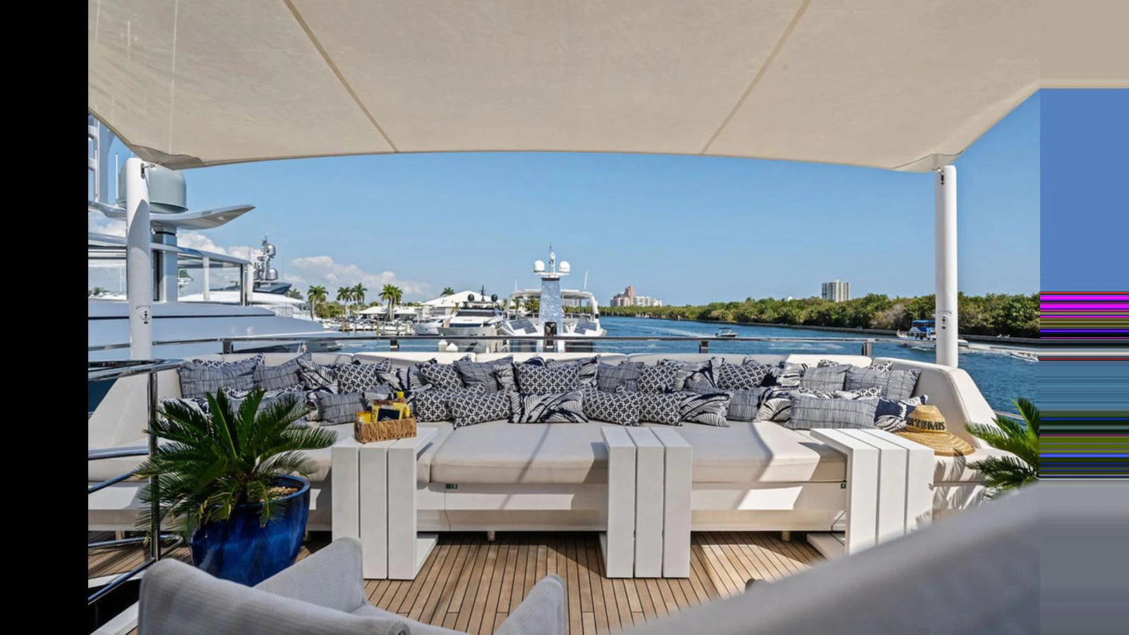 The aft deck features a spacious and comfortable seating area with a scenic view of the marina. aboard ARTEMIS Yacht for Sale