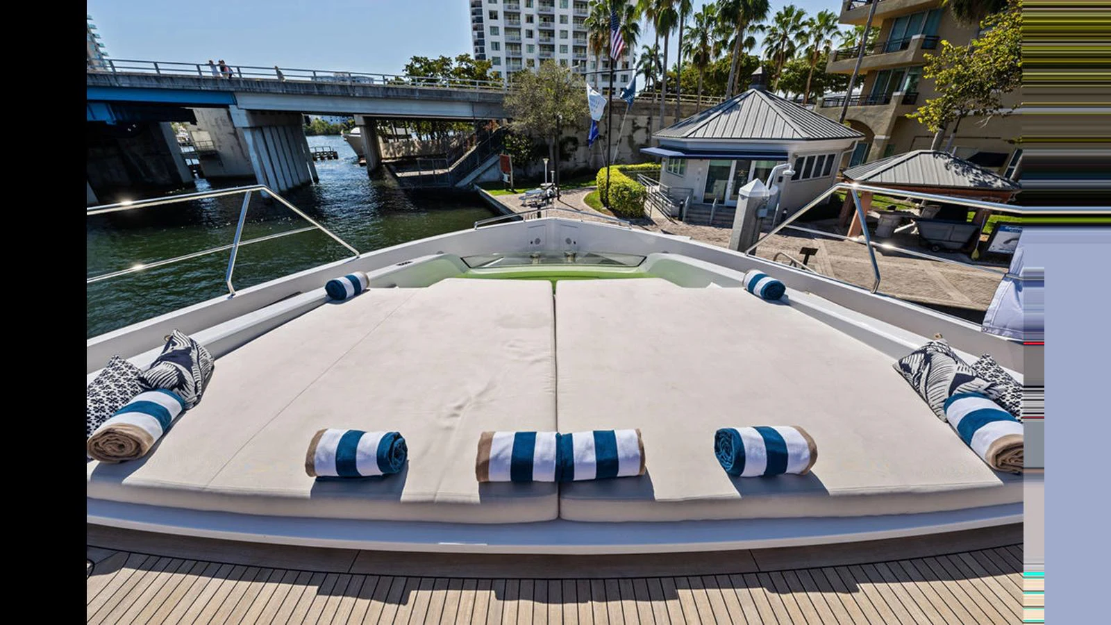 The yacht's sundeck features plush sun pads with rolled towels, perfect for relaxation. aboard ARTEMIS Yacht for Sale