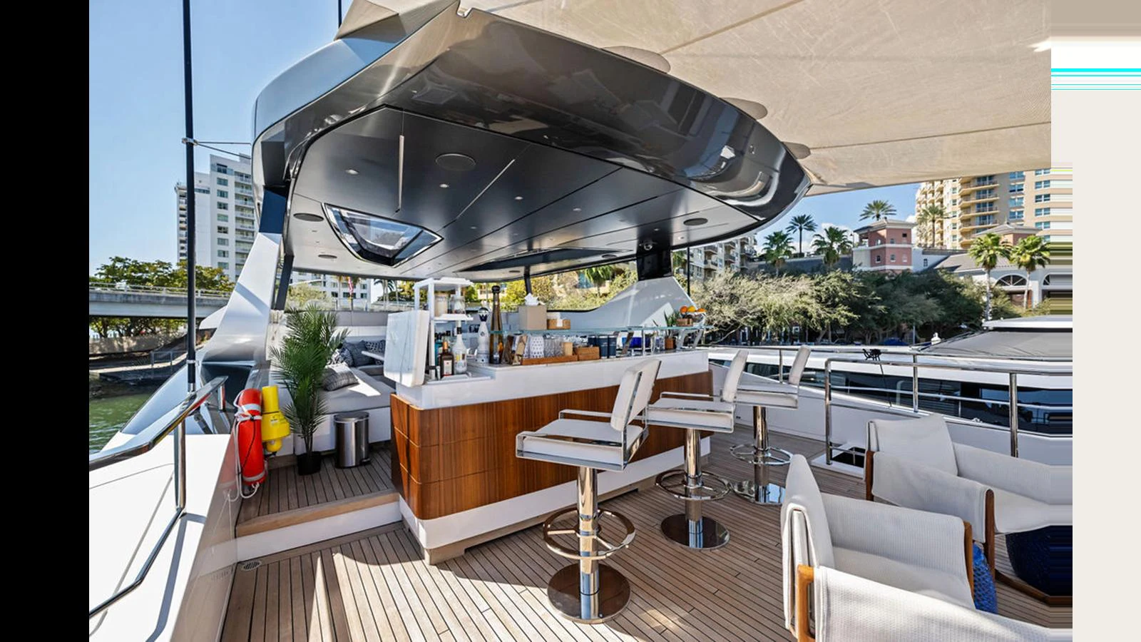 The aft deck features a stylish bar area with modern seating and ample space for relaxation. aboard ARTEMIS Yacht for Sale
