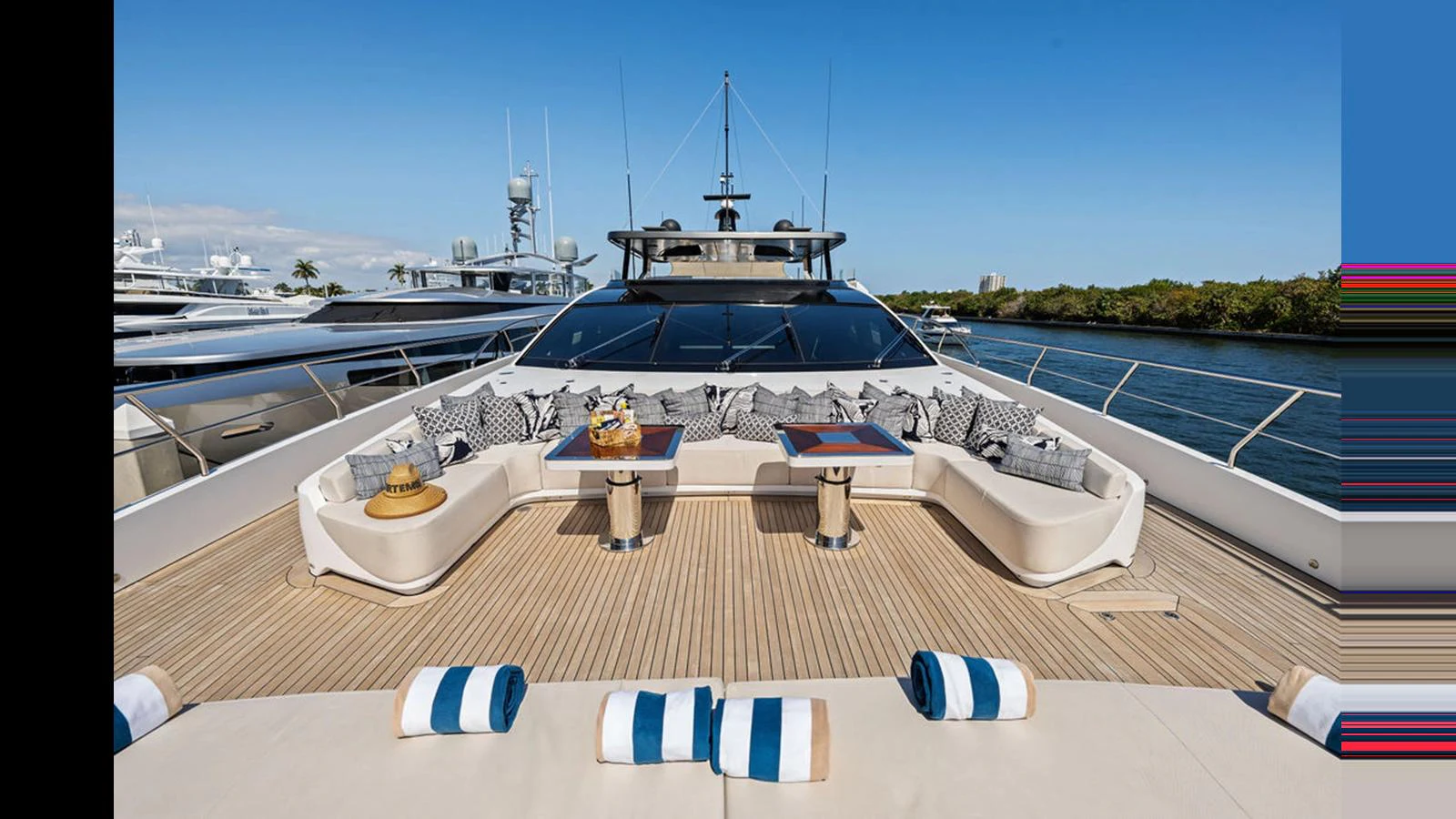 The foredeck features a spacious lounging area with plush seating and elegant tables, perfect for relaxation and socializing. aboard ARTEMIS Yacht for Sale