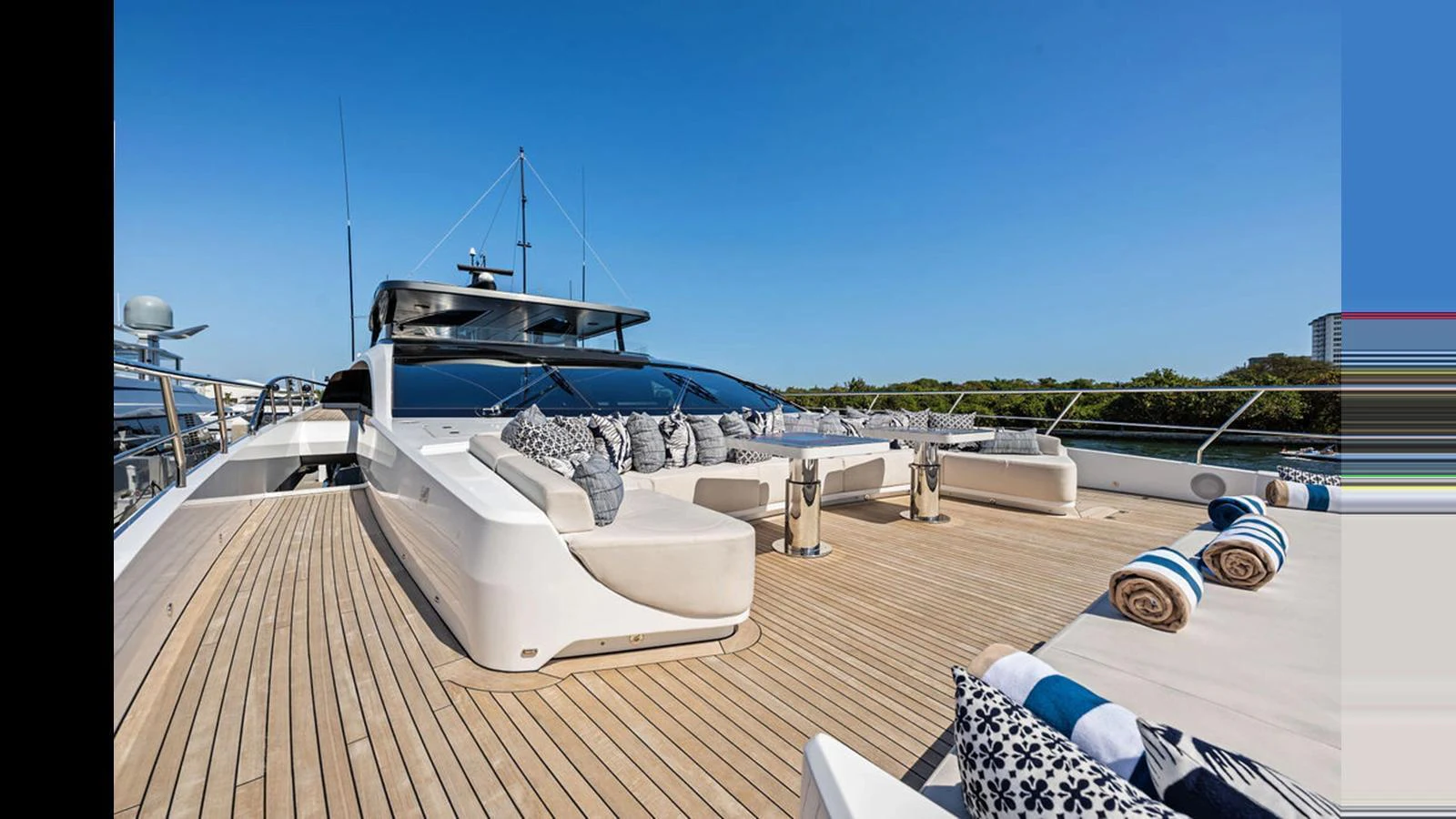 The foredeck of this yacht features luxurious sun loungers and ample seating with plush cushions, perfect for relaxation. aboard ARTEMIS Yacht for Sale