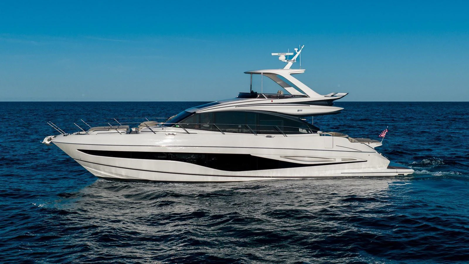 A sleek and modern yacht cruising on calm blue waters under a clear sky. aboard NAUTILUS Yacht for Sale