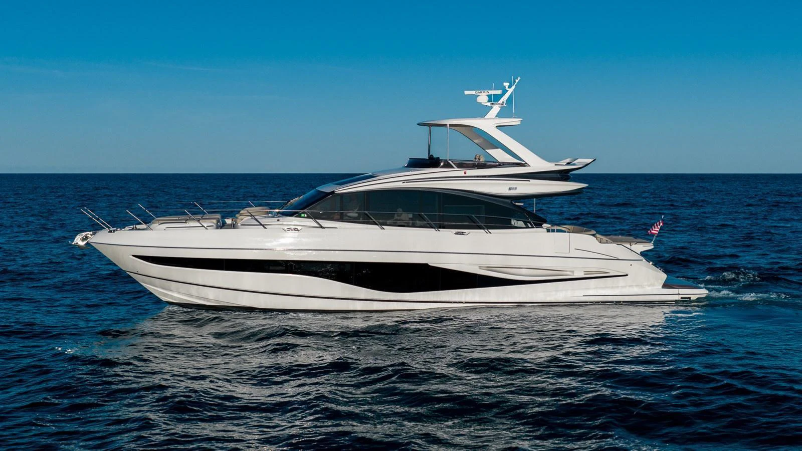 A sleek and modern yacht glides effortlessly on the open sea under a clear blue sky. aboard NAUTILUS Yacht for Sale