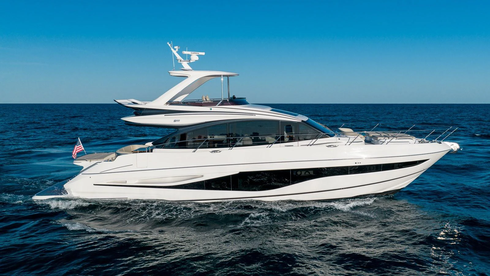 A sleek and modern yacht cruising on the open sea under a clear blue sky. aboard NAUTILUS Yacht for Sale