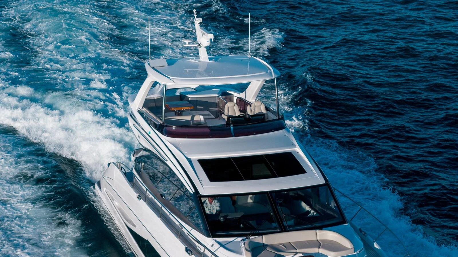 A sleek yacht cruises through the water, showcasing its modern design and luxurious upper deck. aboard NAUTILUS Yacht for Sale