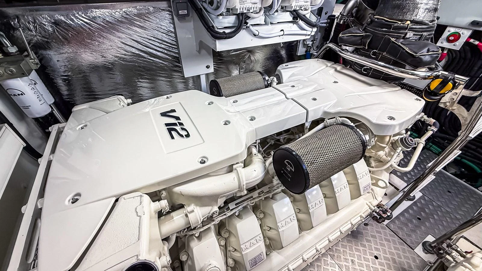 The image showcases a pristine and powerful V12 engine in the yacht's engine room. aboard NAUTILUS Yacht for Sale