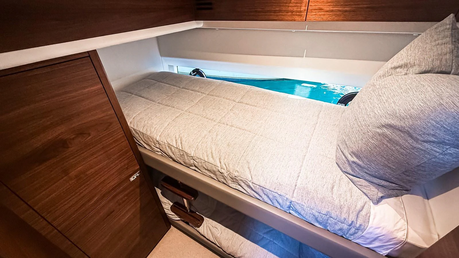 A cozy cabin with a comfortable single bed and wooden accents. aboard NAUTILUS Yacht for Sale