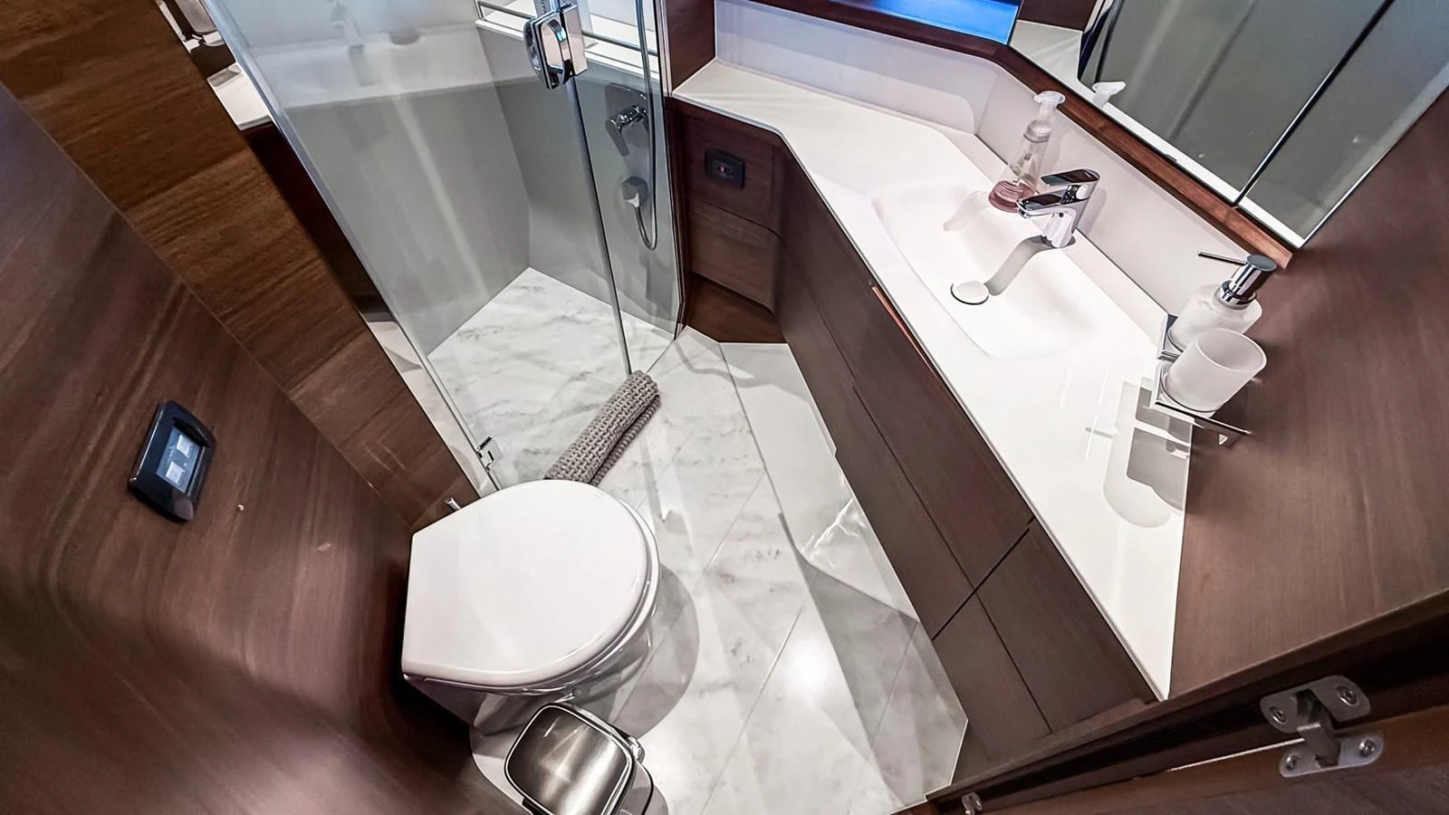 A sleek and modern yacht bathroom featuring a glass-enclosed shower and elegant fixtures. aboard NAUTILUS Yacht for Sale