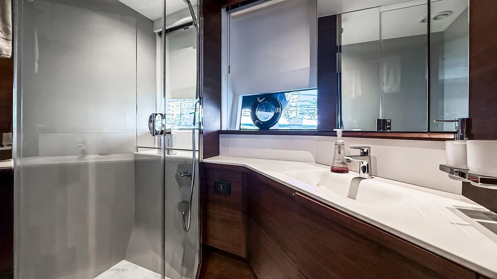 The yacht's bathroom features a sleek design with a glass-enclosed shower and modern fixtures. aboard NAUTILUS Yacht for Sale