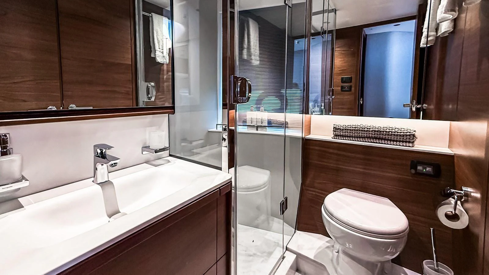 The yacht's bathroom features modern fixtures and a sleek design with wood accents. aboard NAUTILUS Yacht for Sale