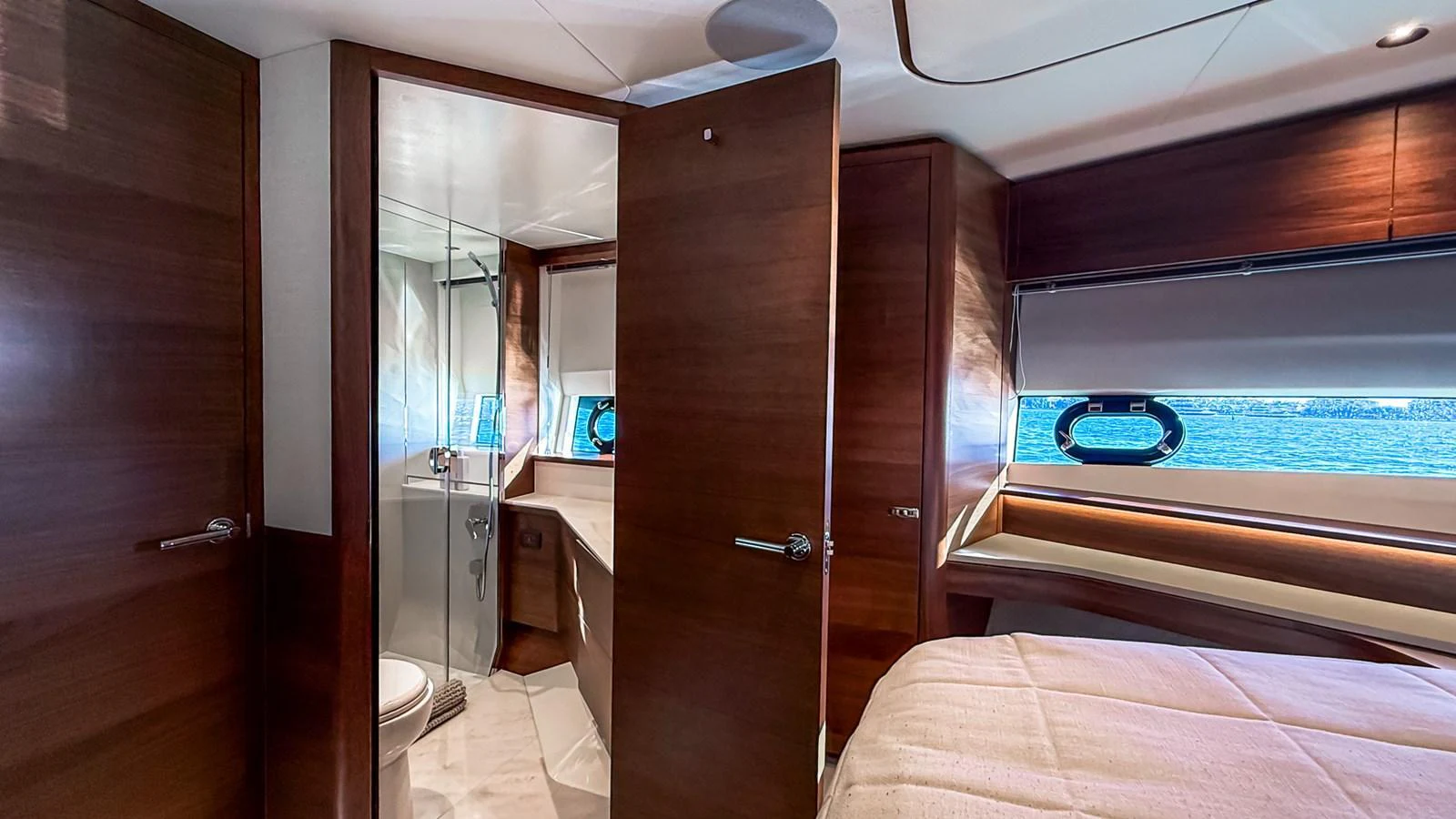 The stateroom features elegant wood paneling, a comfortable bed, and an en-suite bathroom. aboard NAUTILUS Yacht for Sale