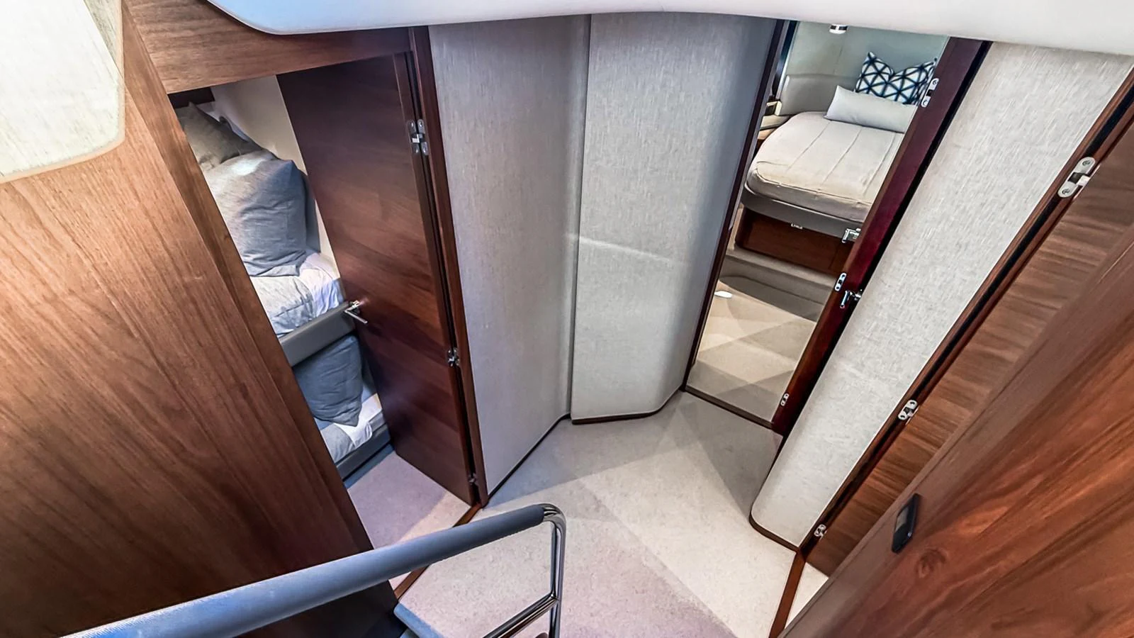 A cozy corridor leading to the staterooms, featuring warm wooden finishes and soft carpeting. aboard NAUTILUS Yacht for Sale