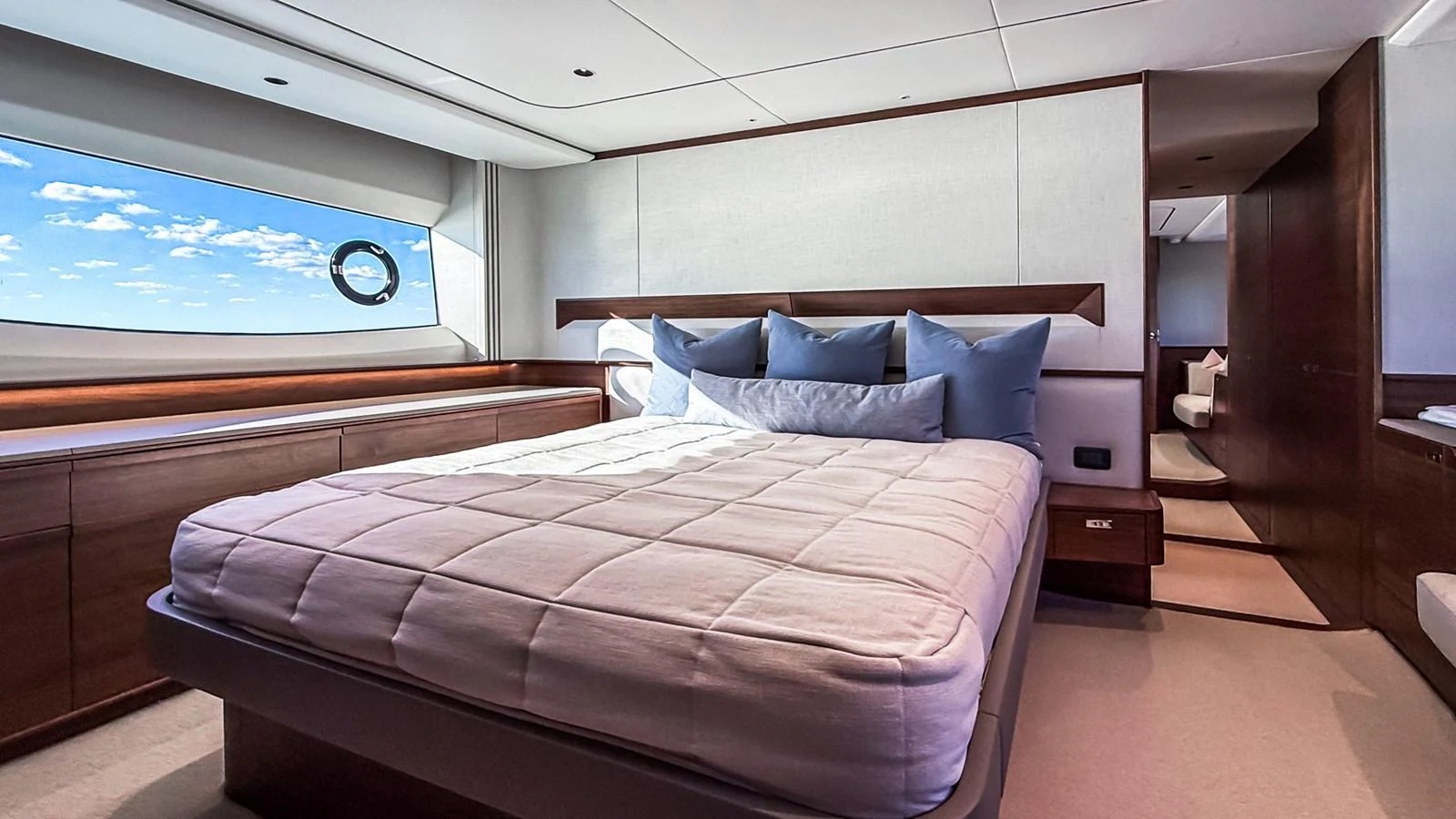 The stateroom features a plush bed with ample natural light from the large window. aboard NAUTILUS Yacht for Sale